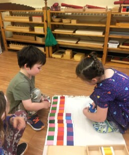 Montessori students using the Colour Box material.