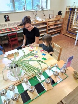 Montessori student learning to match and sort colours using a Montessori material