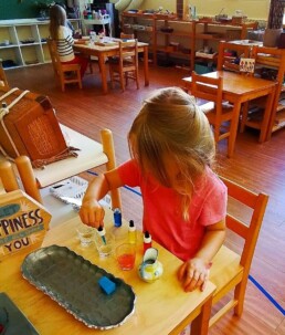 Montessori student learning about mixing colours using droppers.