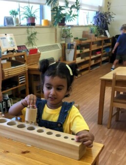 Montessori student during the first day back to school, September 2023. Cylinder Block work for pincer grip development.