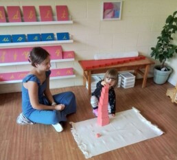 Student working with the classic Montessori Pink Tower material.
