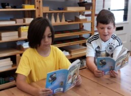 Lyonsgate Montessori elementary students reading a novel together.