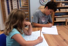 Lyonsgate Montessori Elementary student siblings journaling together.