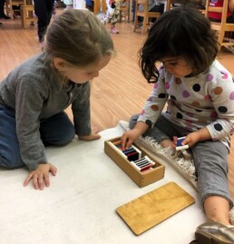 Lyonsgate Montessori students beginning work with a Montessori Colour Box material.
