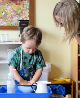 Lyonsgate Montessori toddler student practicing the hand washing activity.