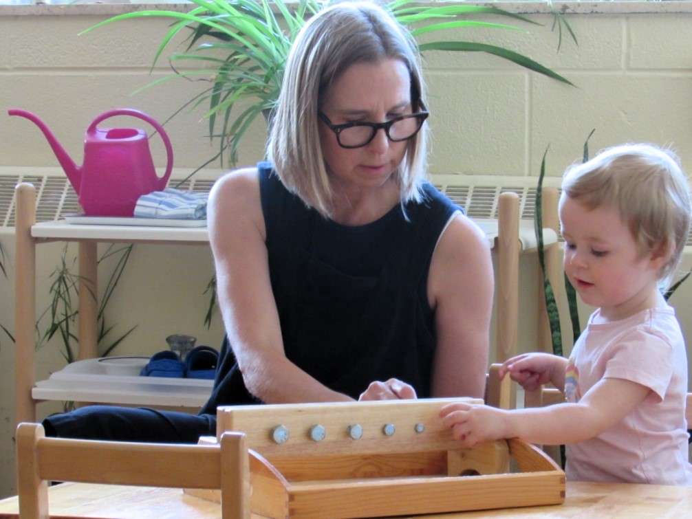 Lyonsgate Montessori student developing motor skills with nuts and bolts.