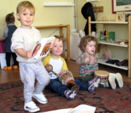 Lyonsgate Montessori toddler students drumming and reading on a Monday morning,