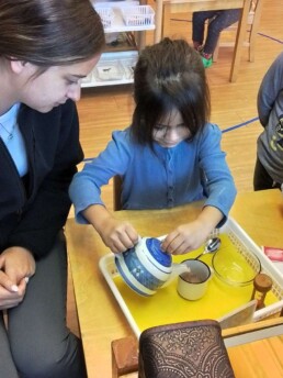 Lyonsgate Montessori student learning to make, and pour, tea