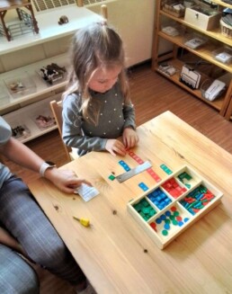 Lyonsgate Montessori student practicing multiplication with the Stamp Game material.