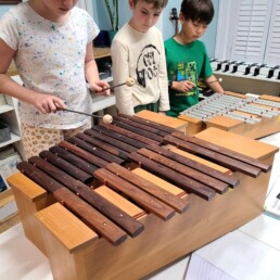 Lyonsgate Montessori students playing the glockenspiel and xylophone together.