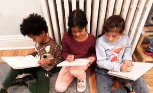 Lyonsgate Montessori Elementary students sketching a comic book.
