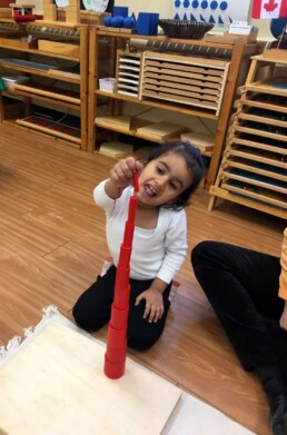 Lyonsgate Montessori student successfully stacking Knobless Cylinders.