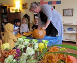 Lyonsgate Montessori Toddler students exploring a pumpkin, inside and out.