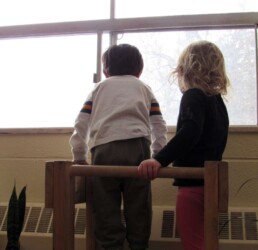 Lyonsgate Montessori Toddler student watching the first snowfall of the year.
