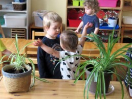 Lyonsgate Montessori Toddler student welcoming her friend with a hug.