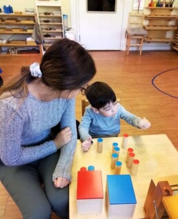 Lyonsgate Montessori student working with the Sound Boxes material to develop auditory discrimination.