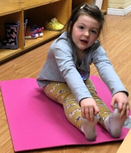 Lyonsgate Montessori student practicing yoga.