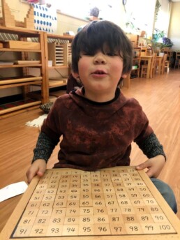 Lyonsgate Montessori Casa student successfully sorting and counting numbers to 100.