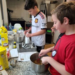 Lyonsgate Montessori Elementary students preparing for a charity fundraising bake sale.