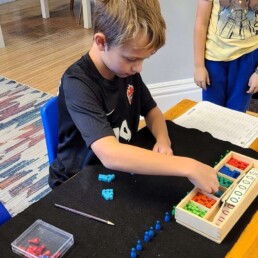 Lyonsgate Montessori Elementary student converting between decimals and percentages.