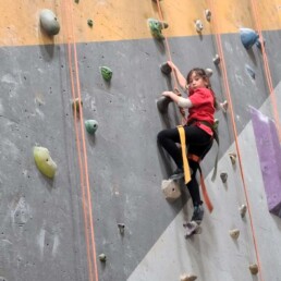 Lyonsgate Montessori Elementary student rock climbing for the first time.