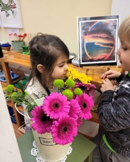 Lyonsgate Montessori Casa students stopping to smell the flowers.