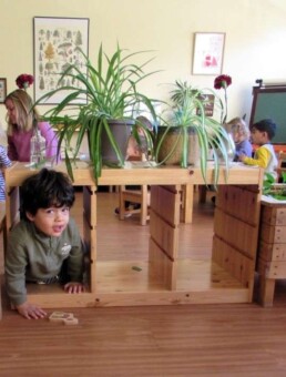 Lyonsgate Montessori Toddler student taking the toddler-sized classroom shortcut.