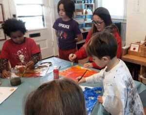 Lyonsgate Montessori Elementary students creating Eric Carle-style art.