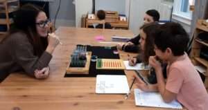 Lyonsgate Montessori Elementary students participating in a Montessori Racks and Tubes lesson.