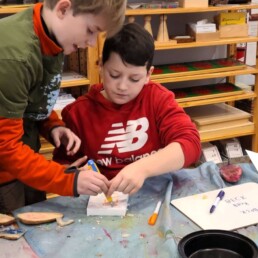 Lyonsgate Montessori Elementary students creating relief prints with pressed foam blocks.