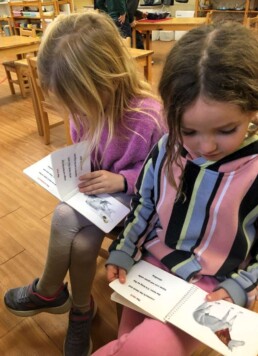 Lyonsgate Montessori Casa students reading about animals together.