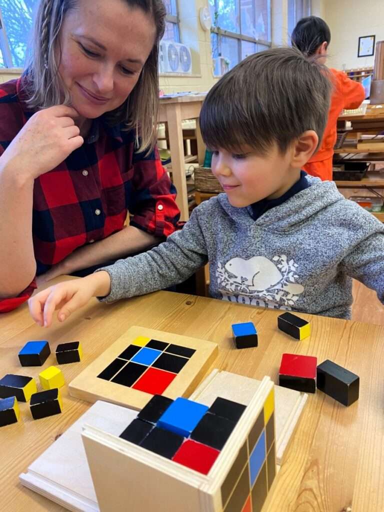 Lyonsgate Montessori Casa student working with the Montessori Trinomial Cube material.