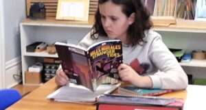 Lyonsgate Montessori Elementary student enjoying some quiet reading time.