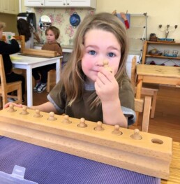 Lyonsgate Montessori Casa student working with the Montessori Cylinder Blocks material.