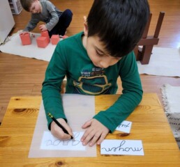 Lyonsgate Montessori Casa student practicing writing in French.