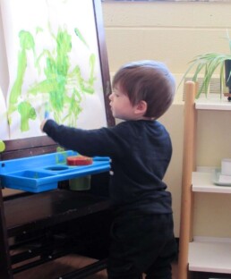 Lyonsgate Montessori Toddler student engaged in his current favourite activity.