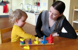 Lyonsgate Montessori Toddler student developing motor skills along with vocabulary for colours and shapes.