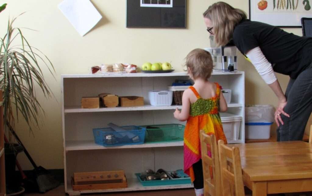 Lyonsgate Montessori Toddler student and guide discussing plans for the next activity.