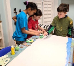 Lyonsgate Montessori Elementary students making the backdrop for their caterpillar model.