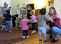 Lyonsgate Montessori Toddler students jumping as part of a morning activity exercise.