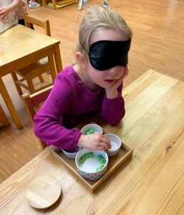 Lyonsgate Montessori Casa student sorting beads while blindfolded.
