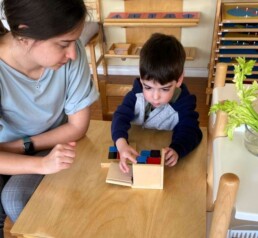 Lyonsgate Montessori Casa student working with the Montessori Binomial Cube material.