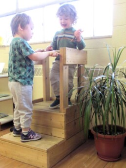 Lyonsgate Montessori Toddler students having a planning meeting about some work on their Lookout Station.
