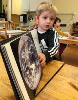 Lyonsgate Montessori Casa student showing an amazing picture of Earth taken from space.
