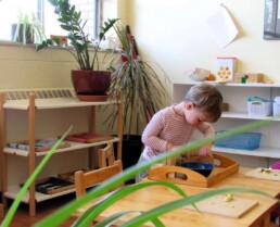 Lyonsgate Montessori Toddler student developing motor and life skills with nuts and bolts.