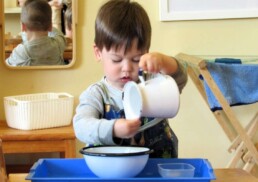 Pouring water is well-loved and developmentally important job for Lyonsgate Montessori Toddler students working on the gross motor skills.