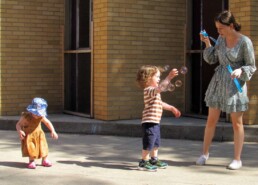 Lyonsgate Montessori Toddler students chasing bubbles.
