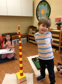 Perhaps inspired by his striped shirt, this Lyonsgate Montessori Casa student worked on focus and perseverance to complete this striped tower with the Montessori Knobless Cylinders material.