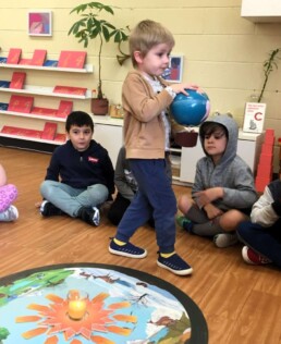 Lyonsgate Montessori Casa student celebrating a birthday by taking the earth on trips around the sun.