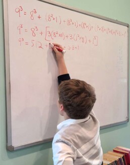 Lyonsgate Montessori School Elementary student recording from a cube to a successive cube.